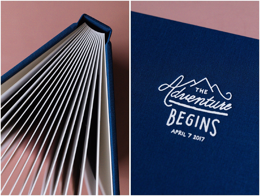 Cover of wedding photography album with white deboss on navy blue linen cover and thick cardstock pages