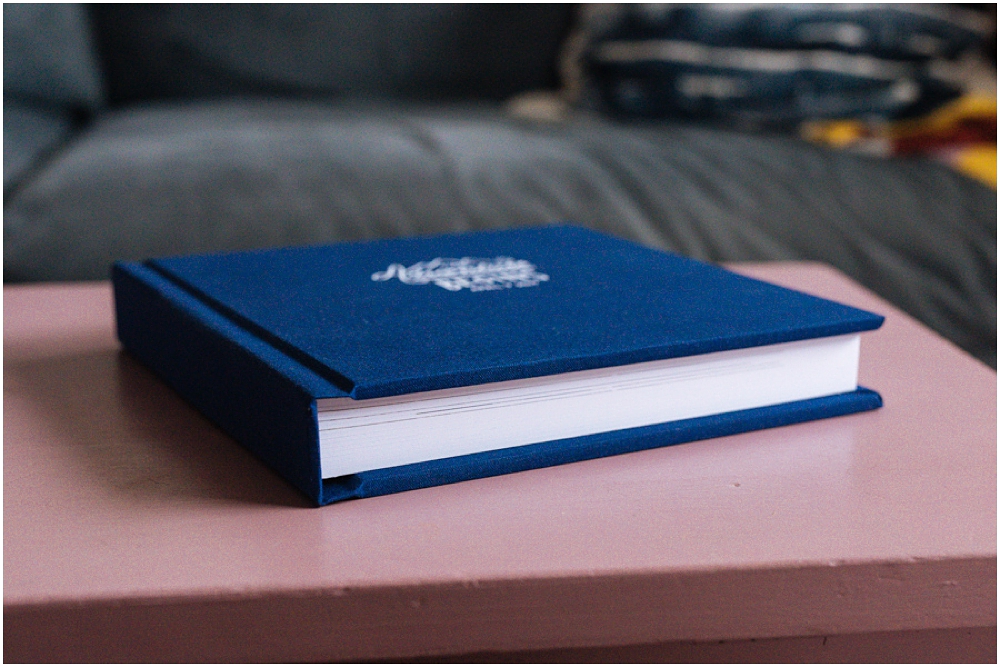 Wedding photography album with white deboss on navy blue linen cover and thick cardstock pages