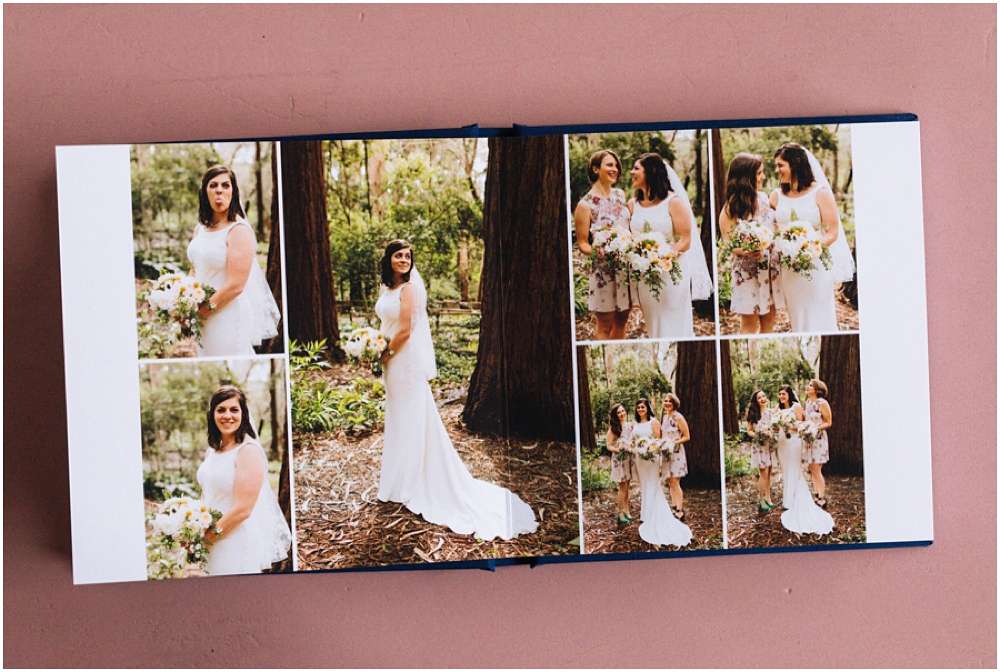 Wedding photography album sits open on pink table showing off design and photos inside showing bride and bridesmaids