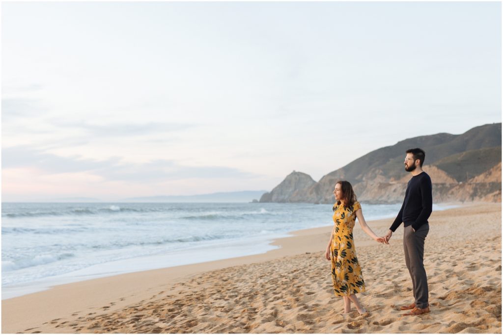 Half Moon Bay engagement photos with an epic view of the coastline and cliffs behind a couple