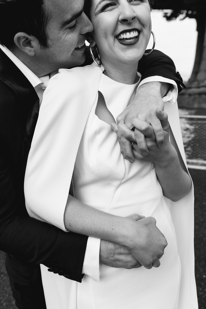 Bride and groom embrace during their Brooklyn elopement in black and white