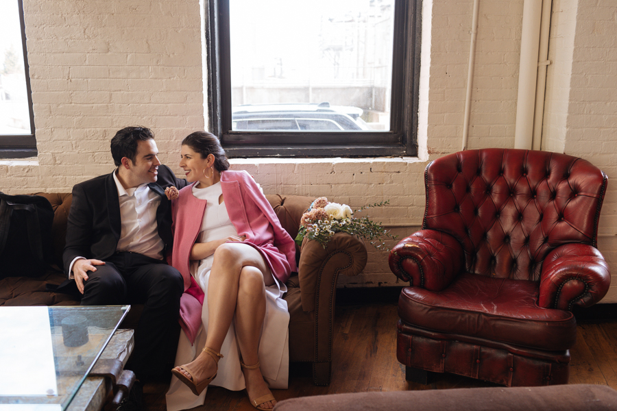 Bride and groom relax in the Brooklyn Roasting Company after their sunrise Brooklyn elopement and have a cup of coffee