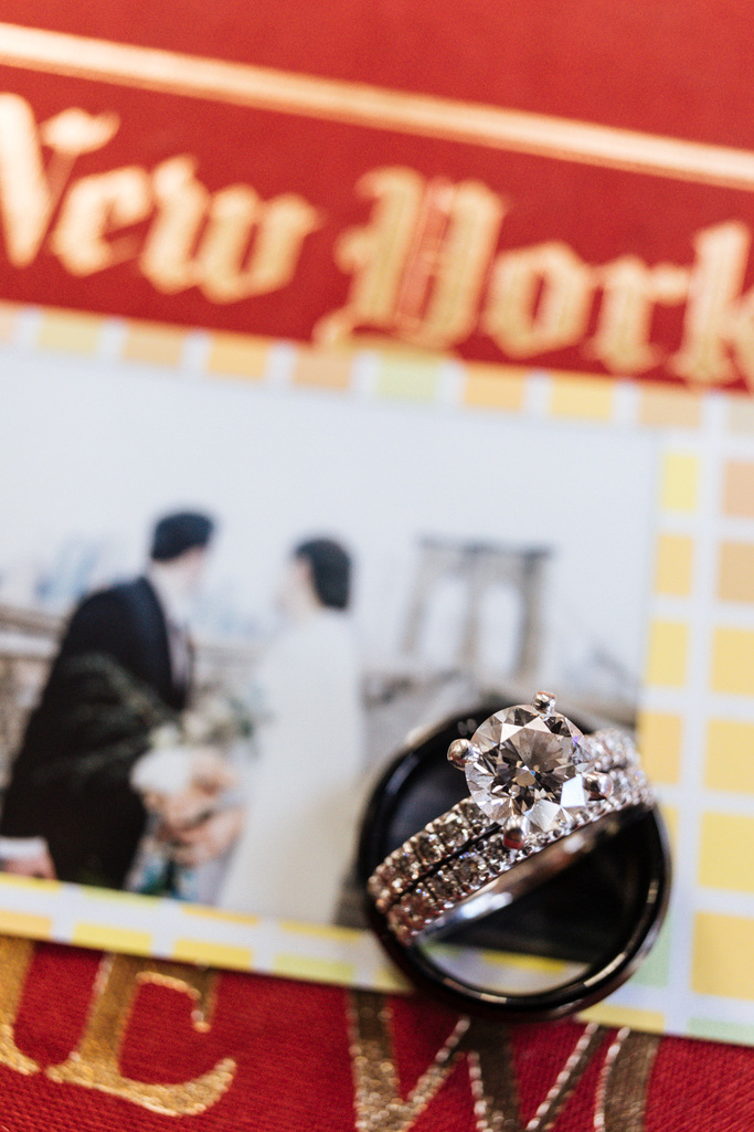 The bride and groom's rings on a New York Times book after their sunrise Brooklyn elopement