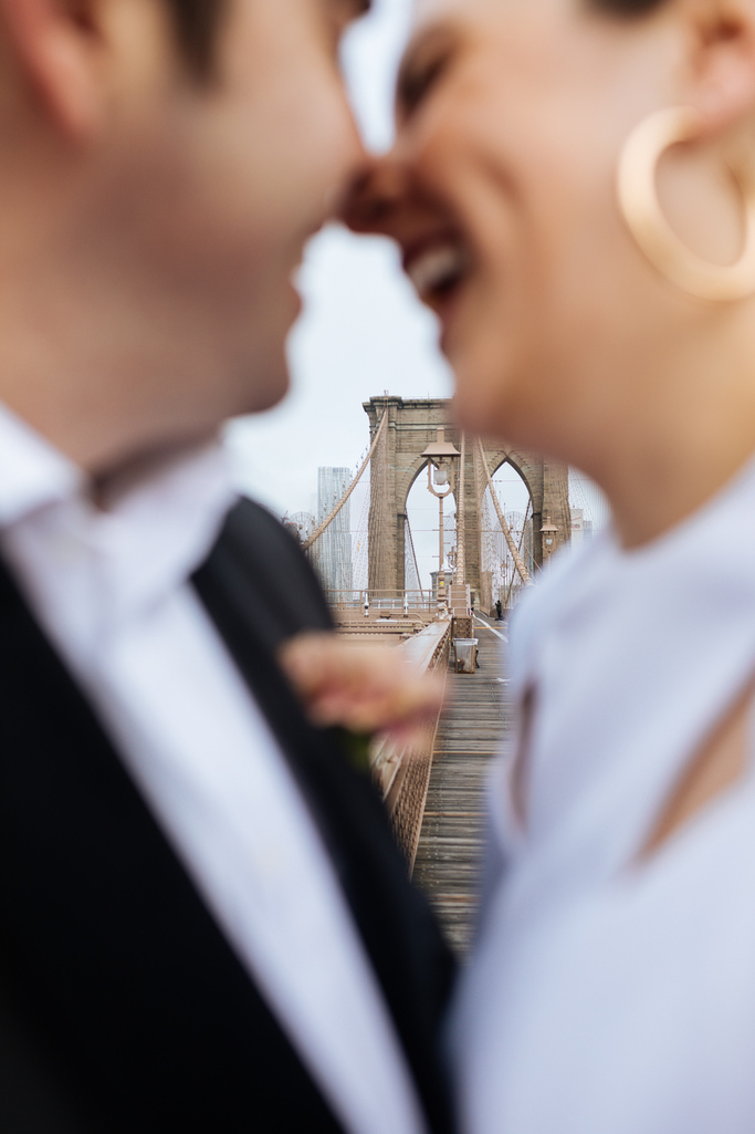 The bride and groom kiss on the Brooklyn Bridge after their Brooklyn elopement