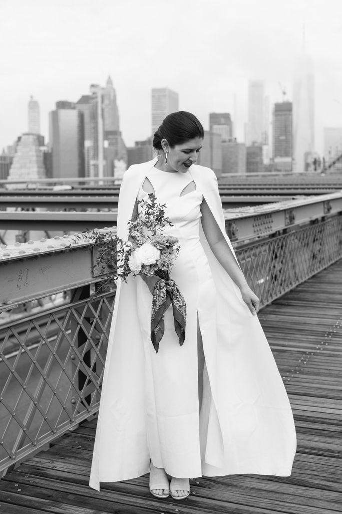 A simple portrait of the bride in black and white during her Brooklyn elopement with New York City behind her