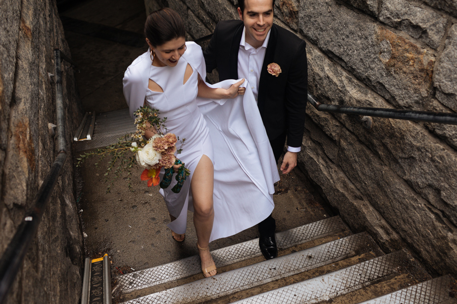 Bride and groom head up the steps to the Brooklyn Bridge during their Brooklyn elopement