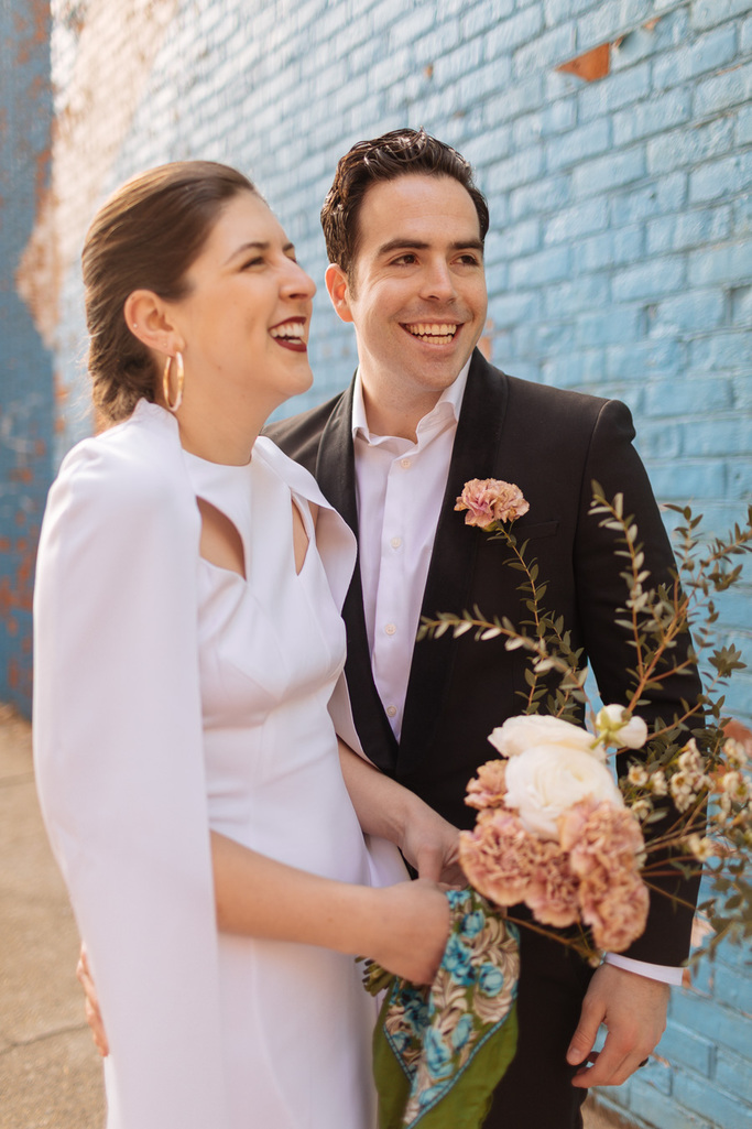 Bride and groom laugh together during their Brooklyn elopement