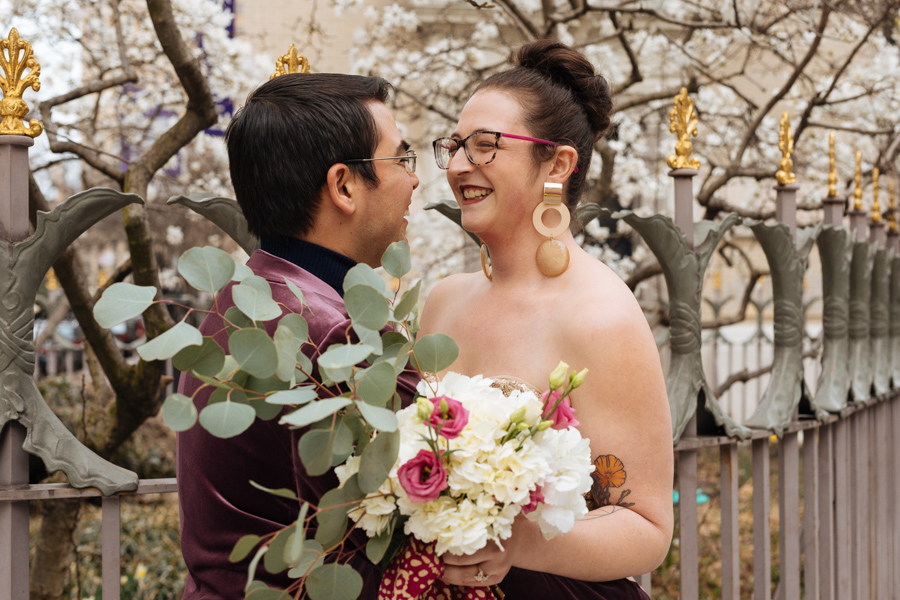 Bride and groom laugh together during their East Village elopement