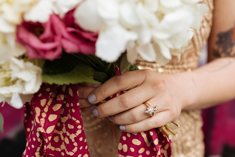 Gold and diamond engagement ring on the bride's finger during her East Village elopement