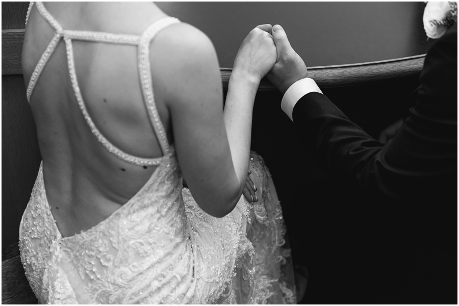 Couple holds hands while at the desk before their ceremony at San Francisco City Hall, California