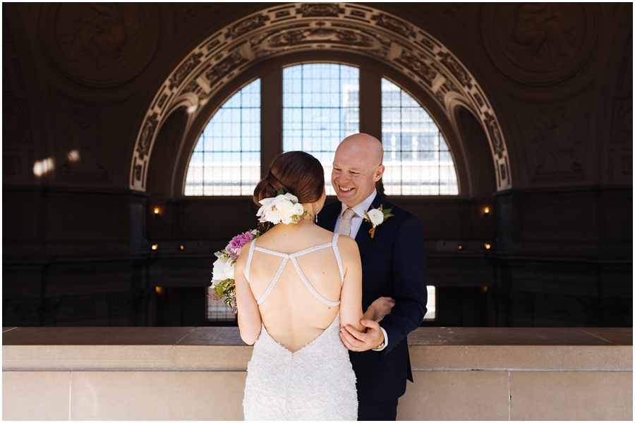 Couple laughs together during their San Francisco City Hall wedding in California