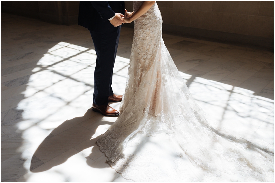 Harsh light makes beautiful portrait of bride and groom holding hands