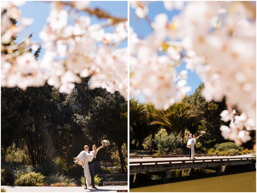 Bride and groom stand under the cherry blossoms during their San Francisco picnic wedding reception
