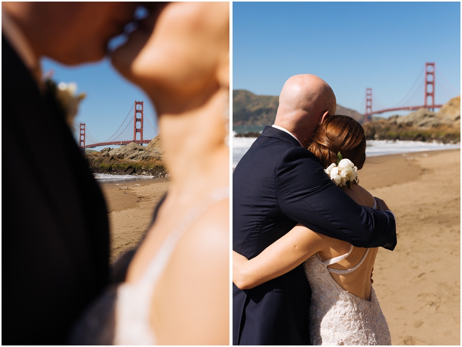 Bride and groom embrace and kiss on the sand at Baker Beach in front of the Golden Gate Bridge during their San Francisco picnic wedding on the beach