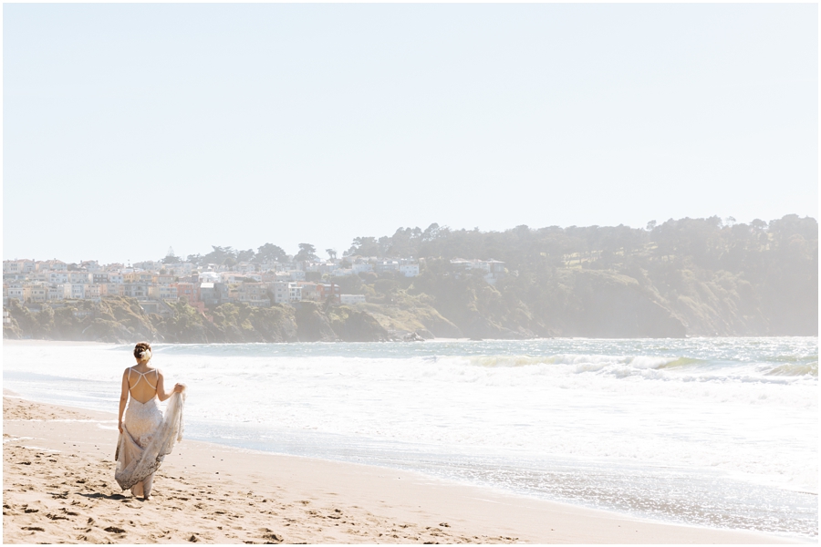 Bride walks down the beach at the end of her San Francisco picnic wedding