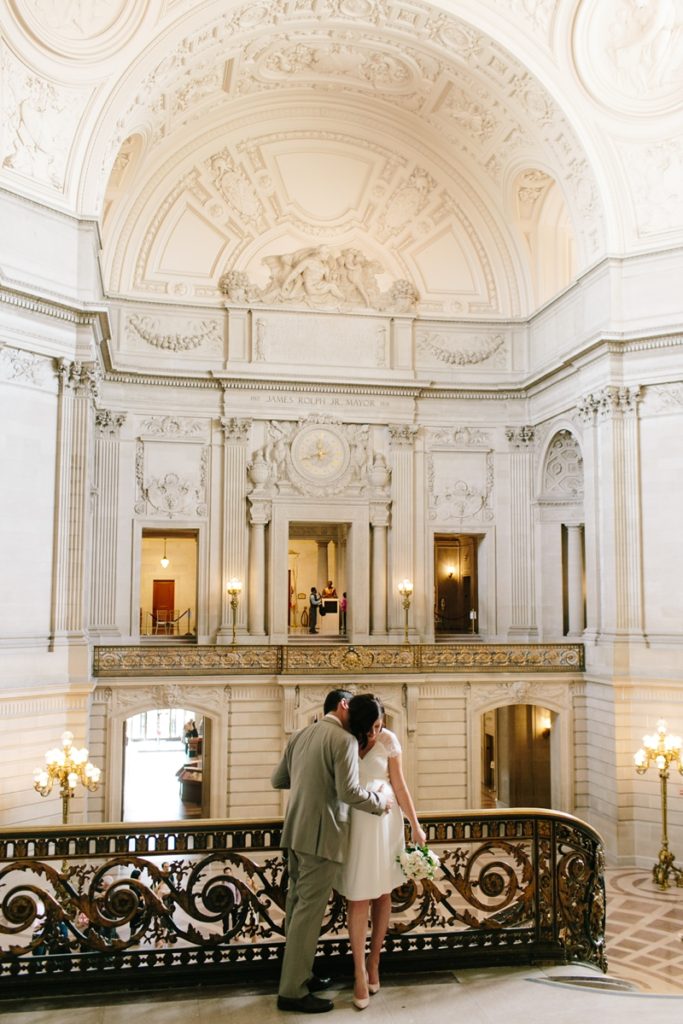 Couple stands and hugs before their San Francisco City Hall wedding
