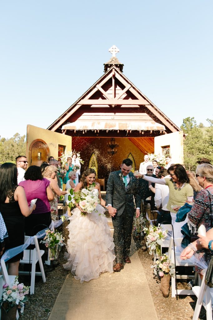 Bride and groom walk down the aisle together after their wedding ceremony at the Long Brand Saloon and Farms, Half Moon Bay wedding venue
