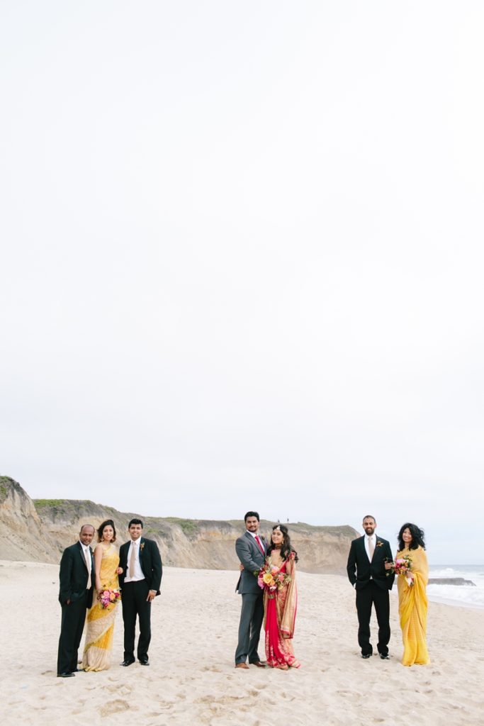 Photo of wedding party and bride and groom on the beach after their wedding ceremony at Half Moon Bay wedding venue Half Moon Bay Golf Links