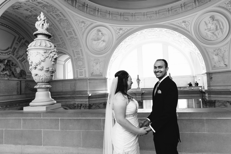 Bride and groom smile together during their one hour San Francisco City Hall wedding