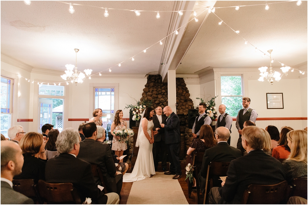 Bride and groom stand and laugh together during their wedding ceremony at Stern Grove