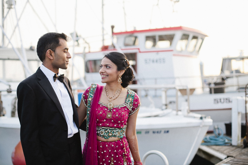 Couples portraits at sunset in the harbor with the boats at Half Moon Bay wedding venue Oceano Hotel and Spa