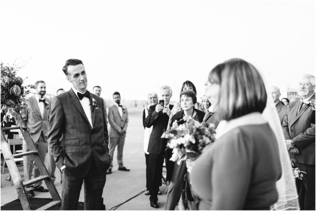 Groom looks at bride as she walks down the aisle - Should We Have a First Look?